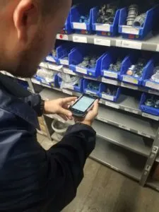 Logistics-clerk-using-a-handhelp-device-to-issue-inventory-1-e1539356033765-225x300