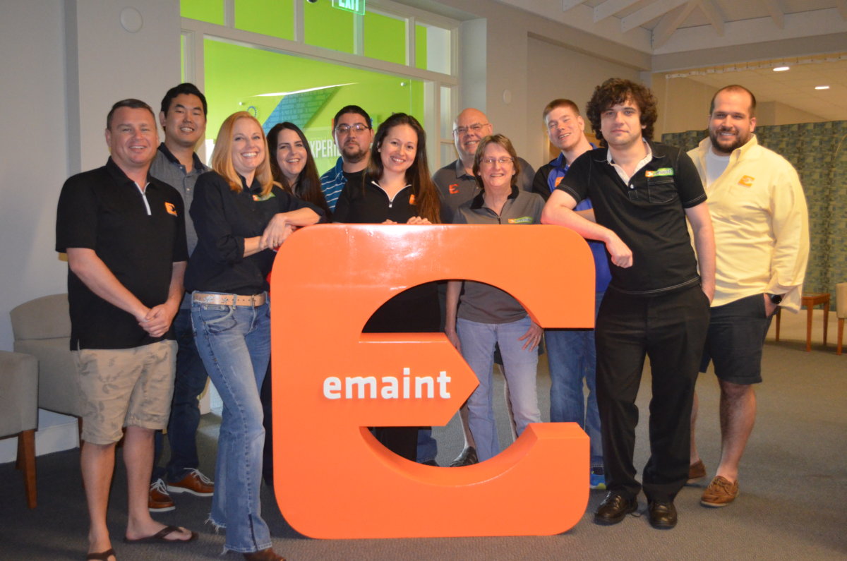 Picture of eMaint team with old eMaint logo
