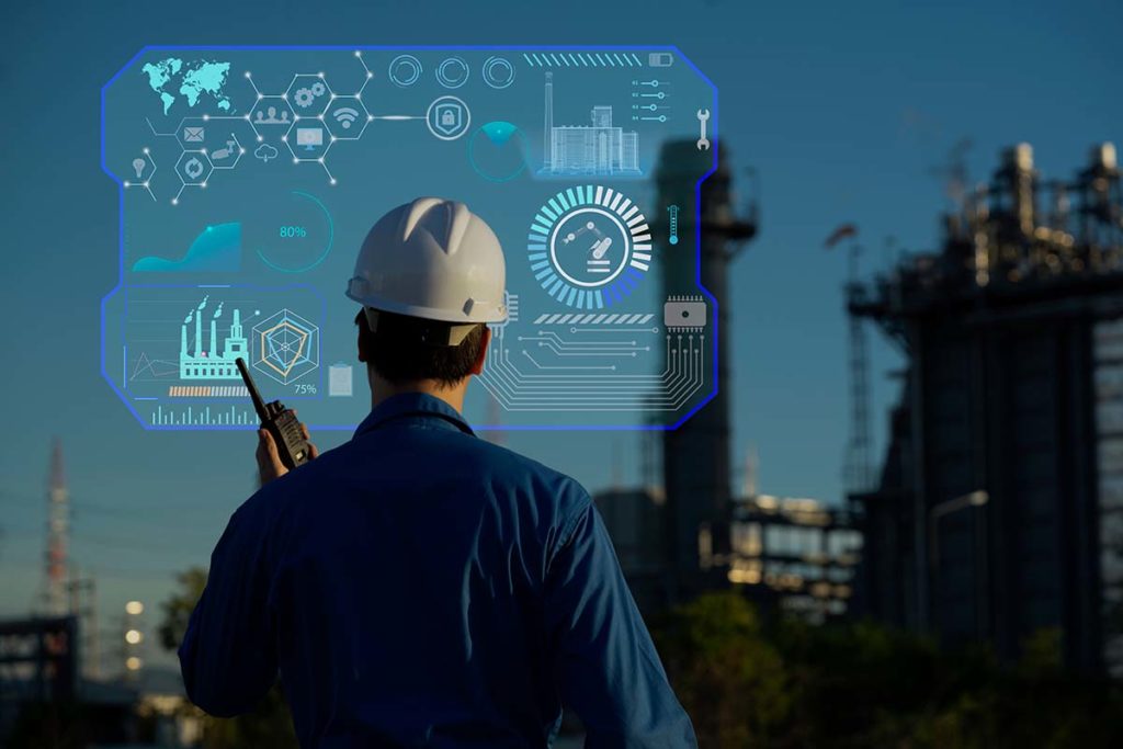 A maintenance worker standing outside in a white hard hat conducting conducting condition-based maintenance on a virtual screen.