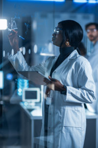 A lab worker uses eMaint CMMS. Computer system validation is required for life science companies. 