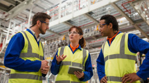 workers discuss inventory management in a factory