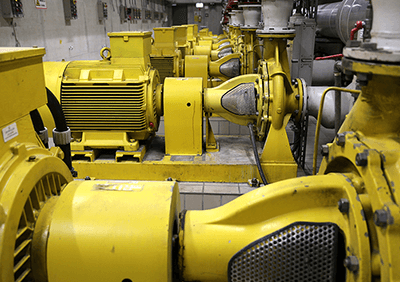 Motors in an industrial setting. A CMMS helps manage the lifecycle of motors and other assets.