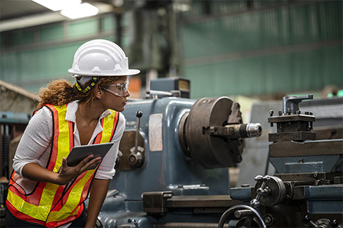 A maintenance worker evaluates an asset on her route using a mobile EAM software.