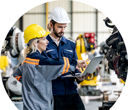 Woman wearing yellow hardhat pointing to tablet that man with white hardhat is holding