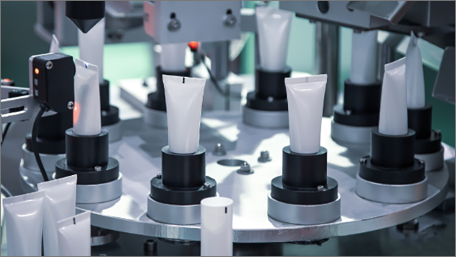 Plastic tubes on a circular metal plate in a product packaging plant